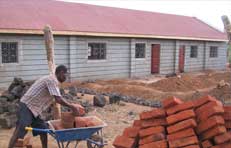Picture of a man helping to build the Kisayani unit
