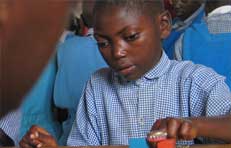 Picture of a school boy playing with bricks